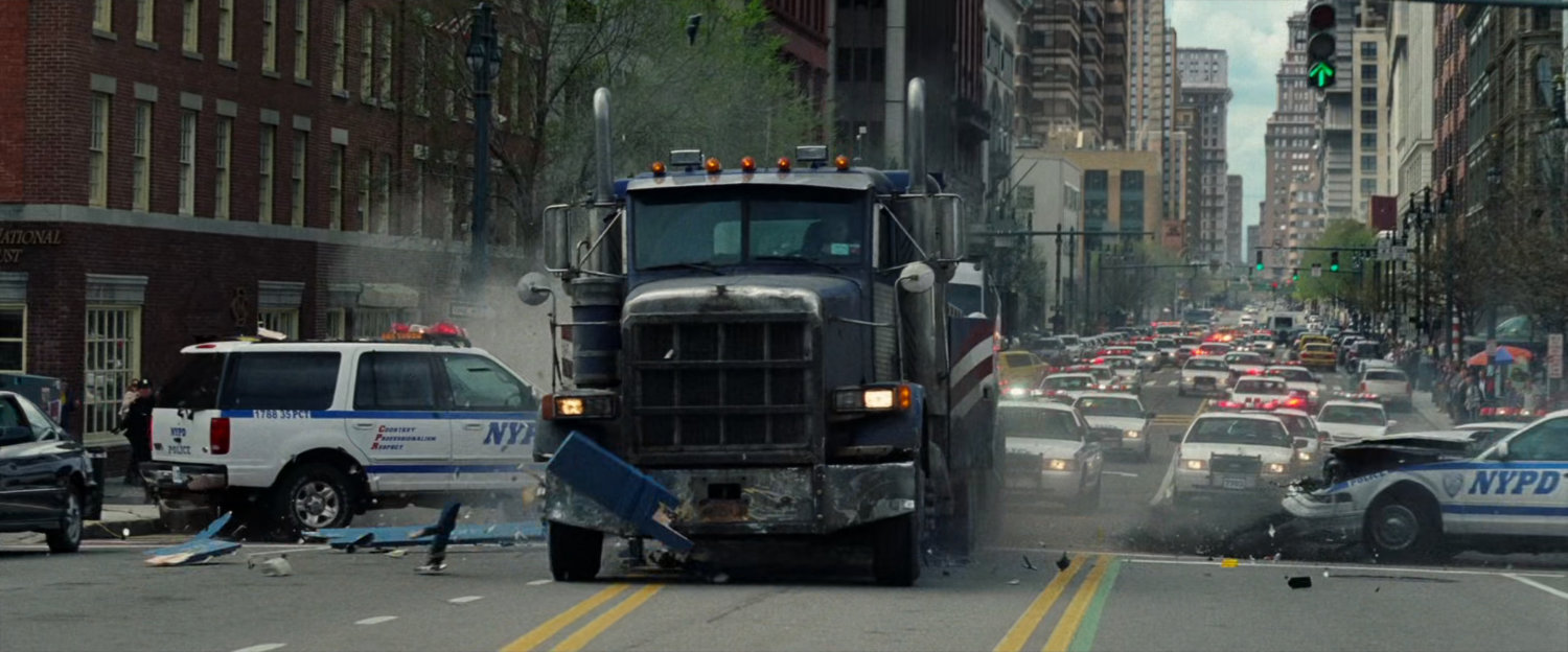 Tow truck crashes through police cars.