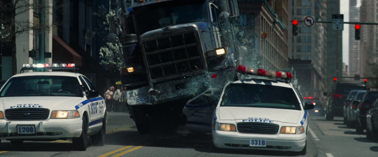 Tow truck runs over police car.