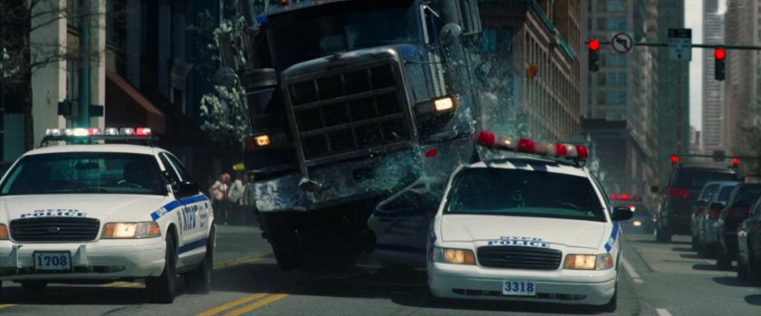 Tow truck runs over police car.