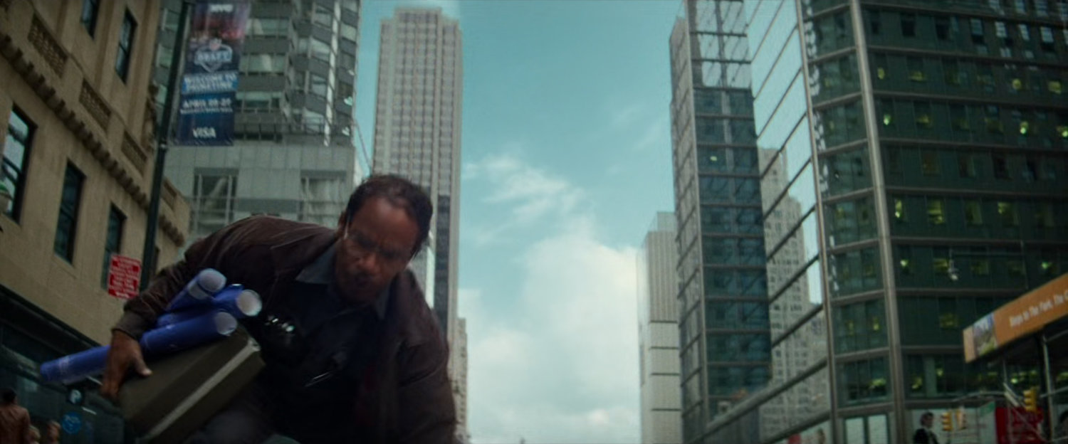 Max Dillon picking up blueprints in middle of street.