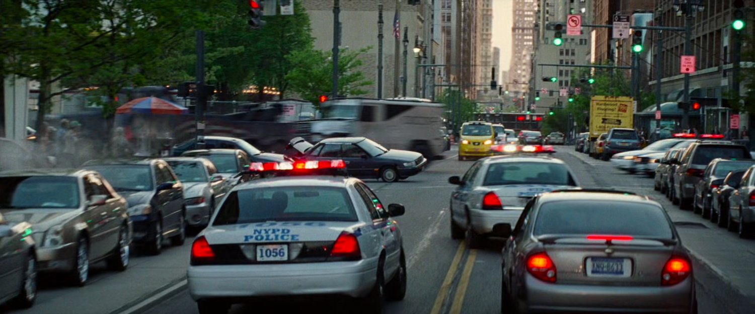 Police cars on New York street chase stolen armored car.