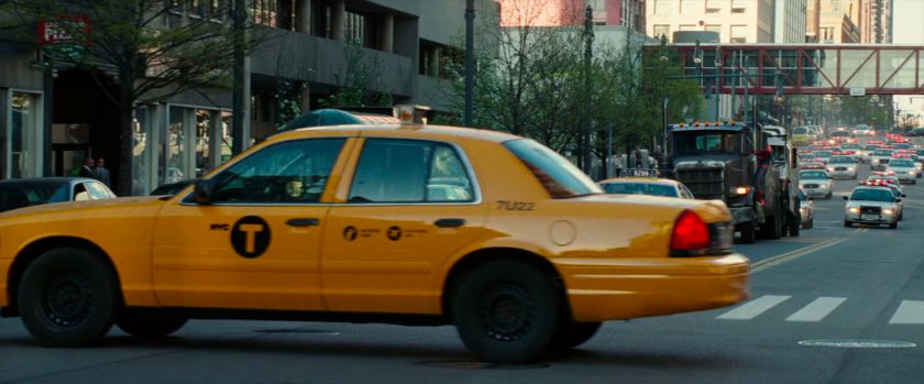 Tow truck heads towards taxi cab.