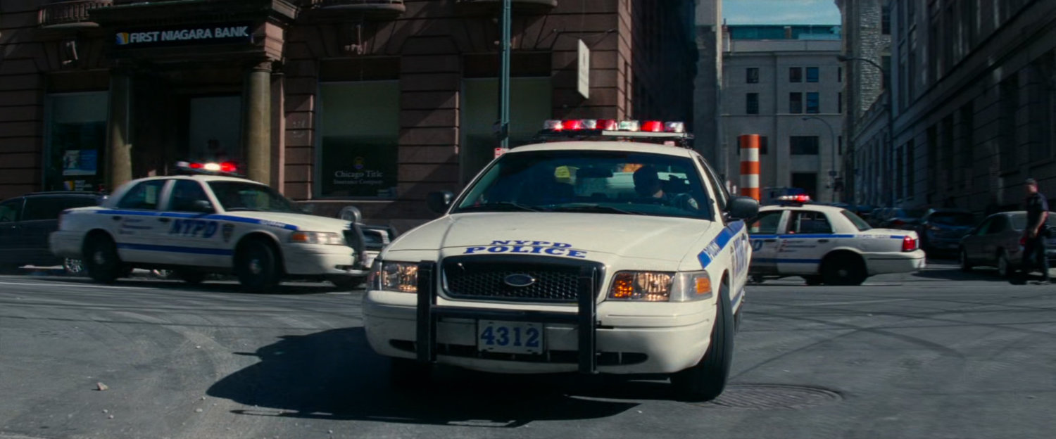Police cars block off street.