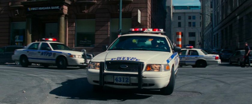Police cars block off street.