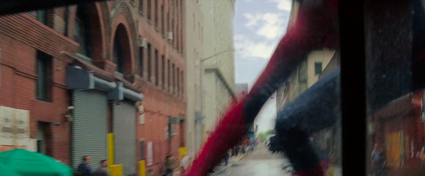 Spider-Man lands on the hood of tow truck.