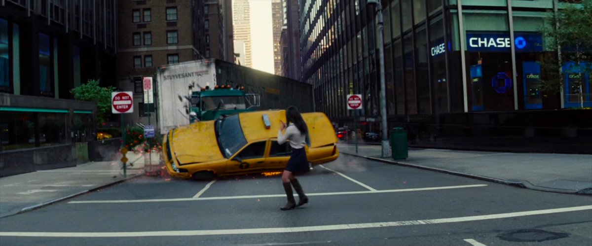 Woman in crosswalk almost hit by semi-truck and taxi cab.