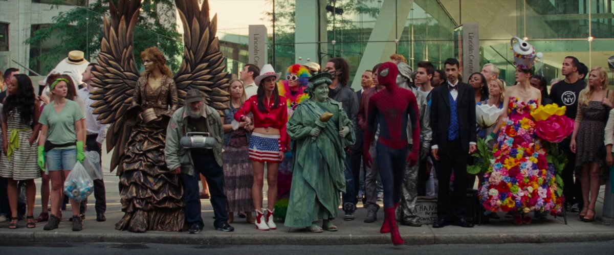 Spider-Man and a bunch of people in costumes outside Lincoln Center.