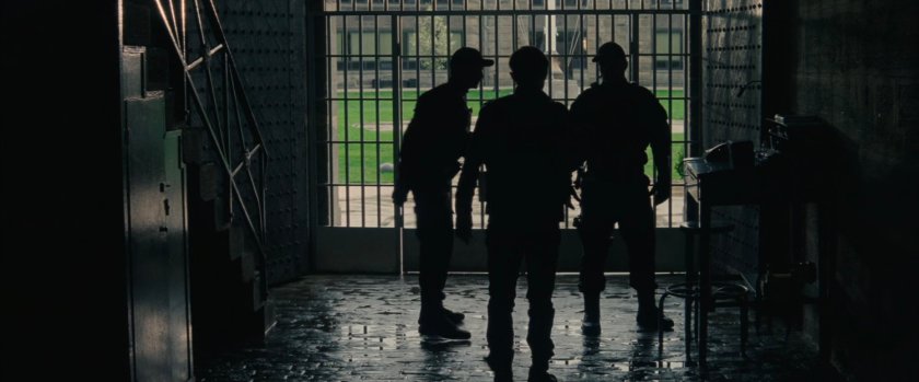 Silhouetted men inside Ravencroft Institute.