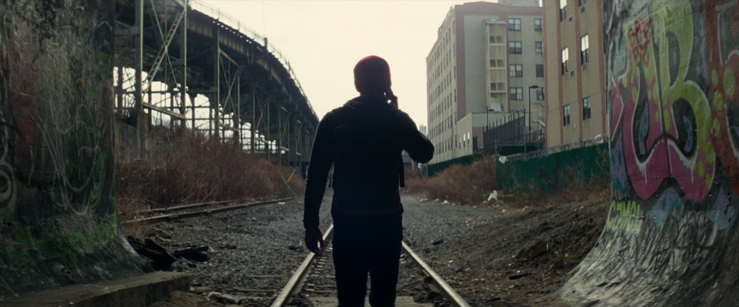 Silhouetted Peter Parker exits tunnel.