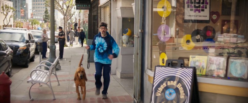 A jogger and his dog on a San Francisco sidewalk.