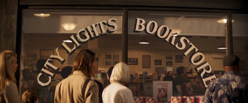 People looking through window of City Lights Bookstore.