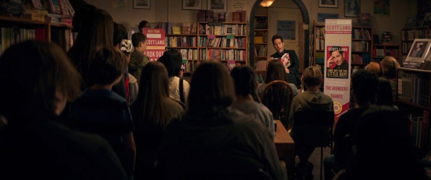Scott Lang reading from his book to a crowd inside bookstore.