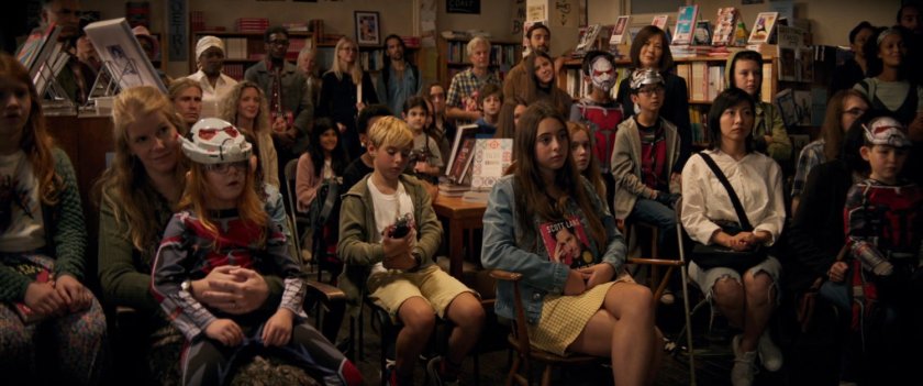 A crowd inside bookstore listening to Scott Lang read from his book.