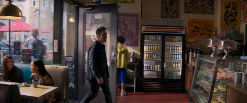 Scott enters Bridge Donuts store.