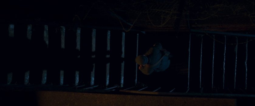 Agent Ross descending stairs.