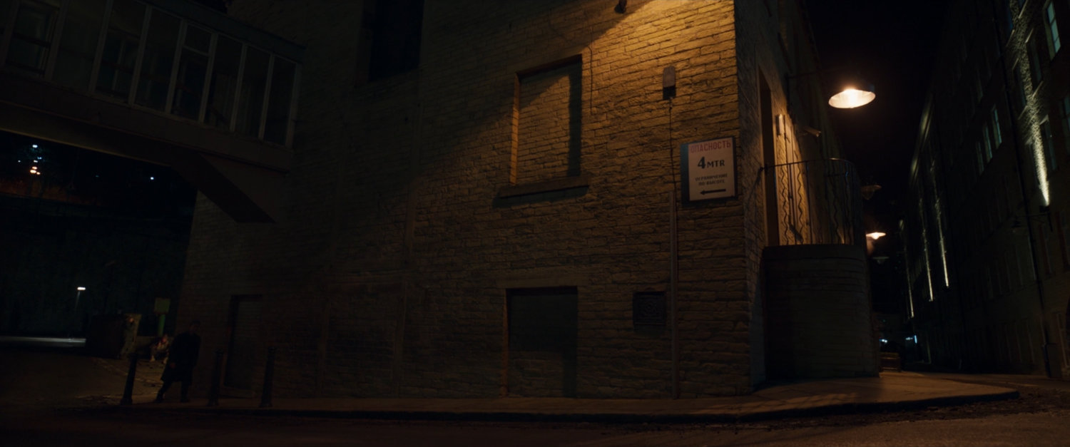Agent Ross walking towards Agent Prescod's building.