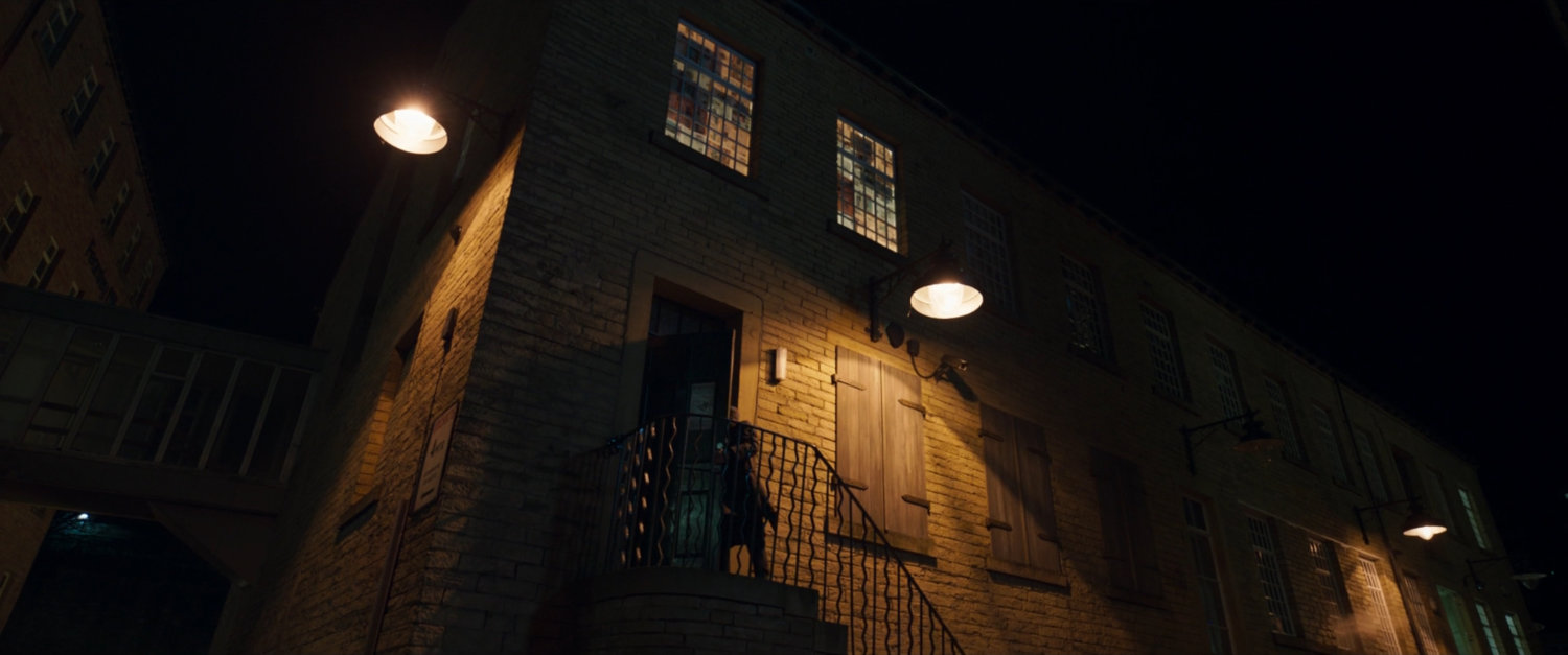 Agent Ross entering Agent Prescod's building.