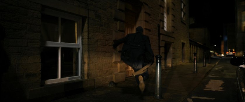 Agent Ross running on Moscow sidewalk.