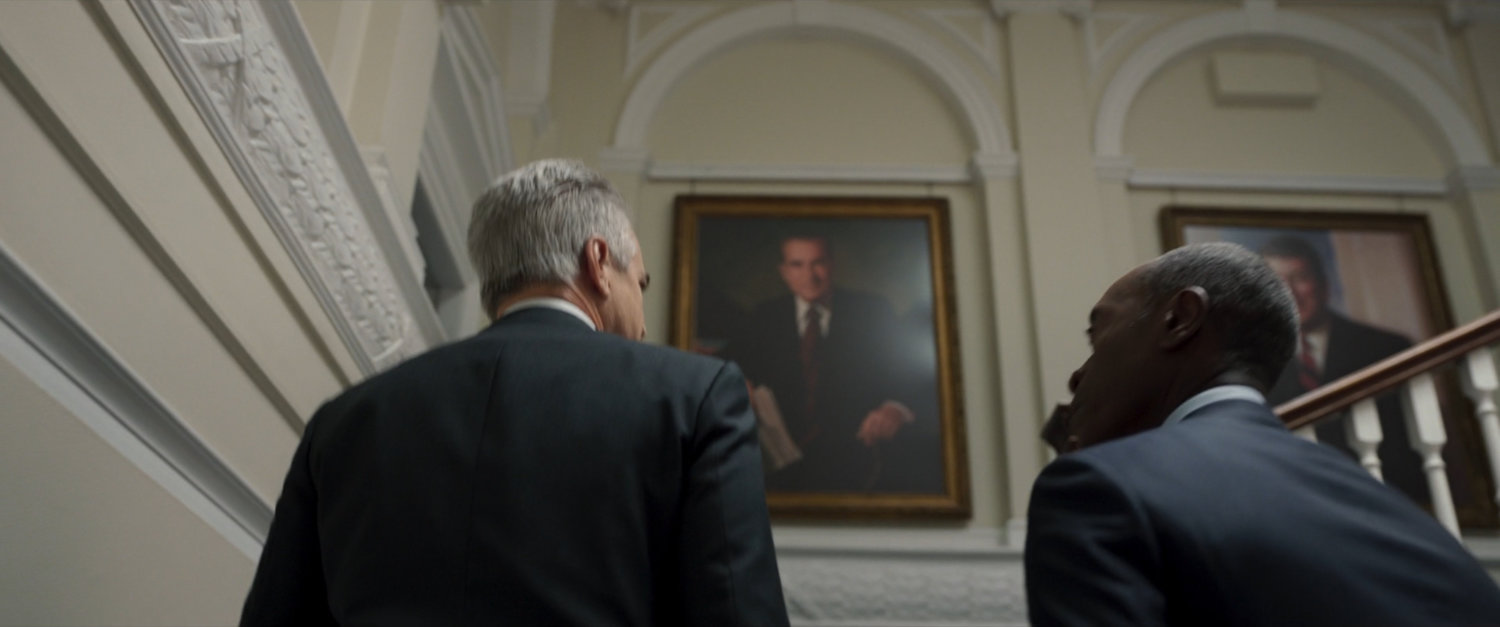 James Rhodes and President Ritson ascend stairs in the White House.