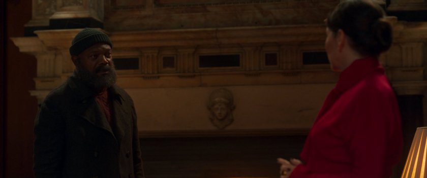 Sonya Falsworth and Nick Fury by a large marble fireplace.