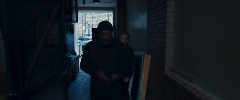 Nick Fury and Talos in a gated alley.