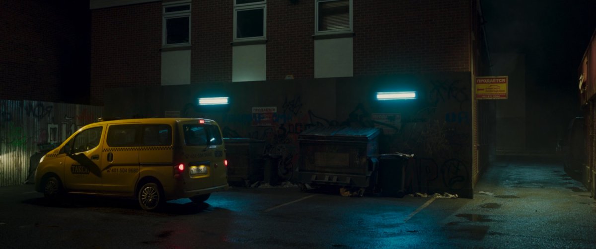 Taxi pulled into Moscow back alley at night.