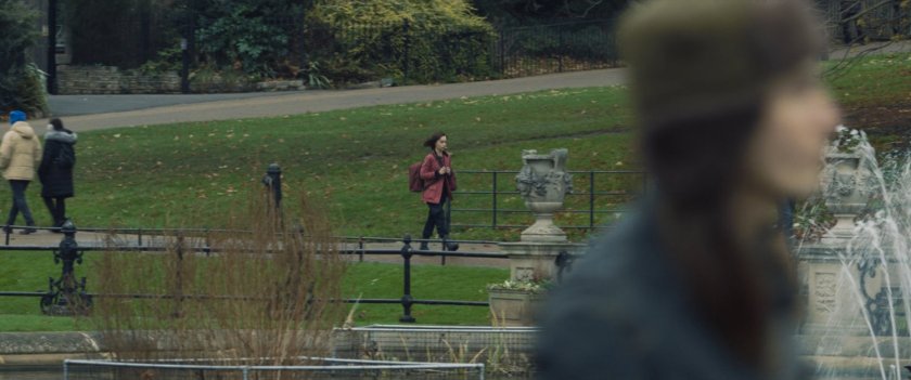 G'iah walking across a Russian park with backpack.