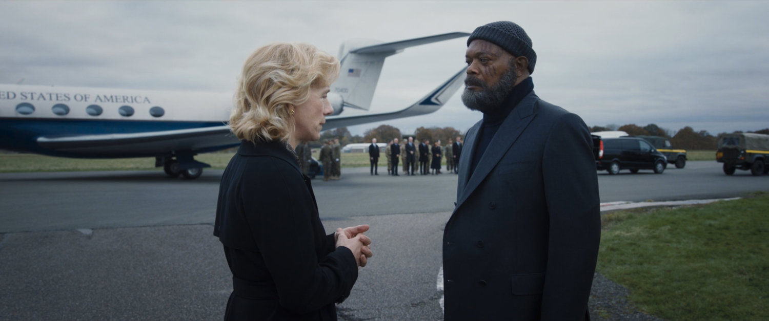 Nick Fury consoles Elizabeth Hill on a runway in front of a plane.