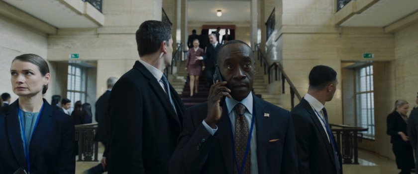 Colonel Rhodes on the phone with his security detail inside of government offices in London.