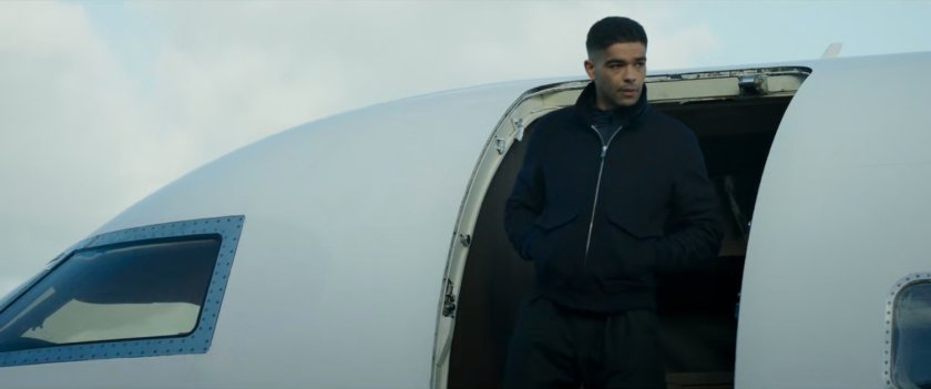 Gravik exits a small private plane.