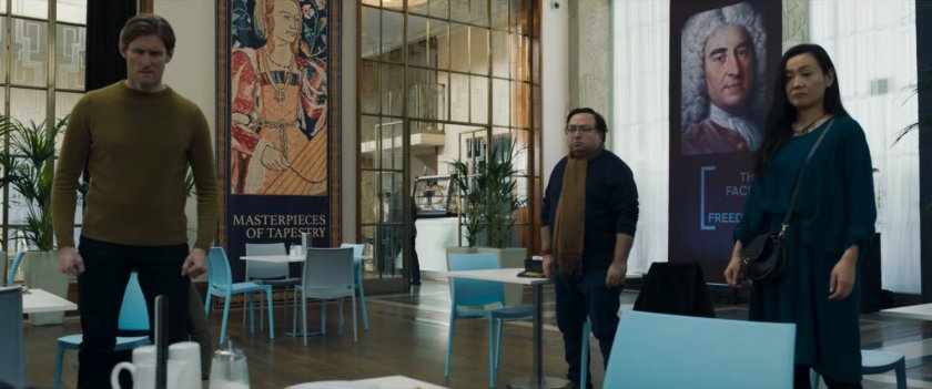Three onlookers watch Gravik in the cafeteria of the London Portrait Gallery.