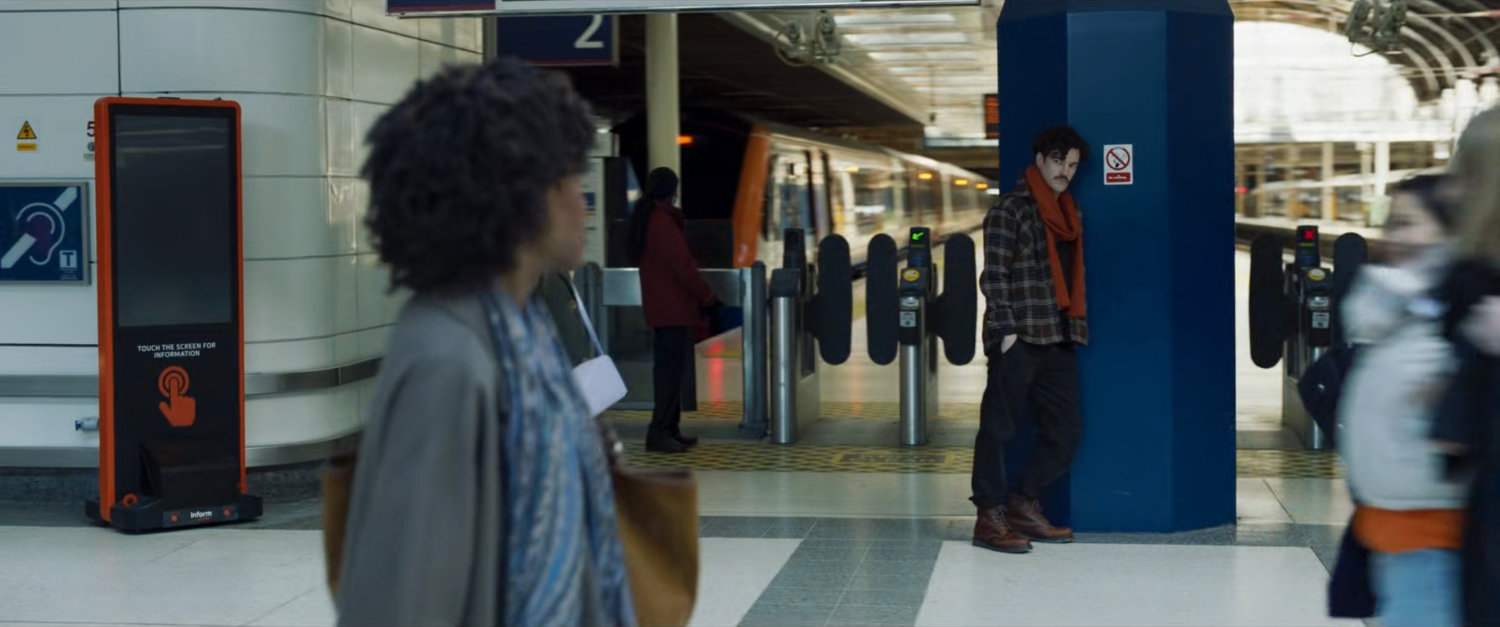 Priscilla sees a strange man while walking through a London train station.
