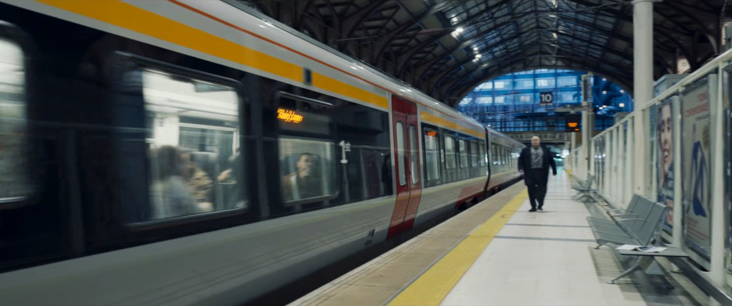 A train stopped inside a London train station.