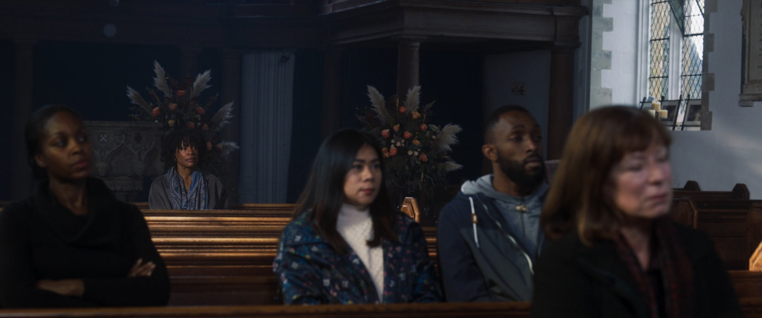 Priscilla sits in St James Church in London listening to the choir.