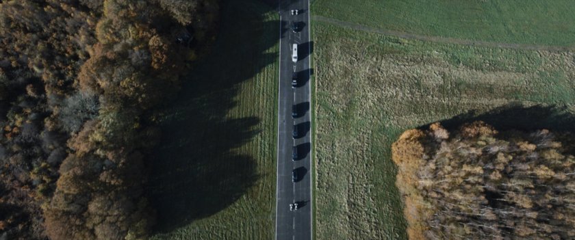 Aerial view of a presidential motorcade on a highway.
