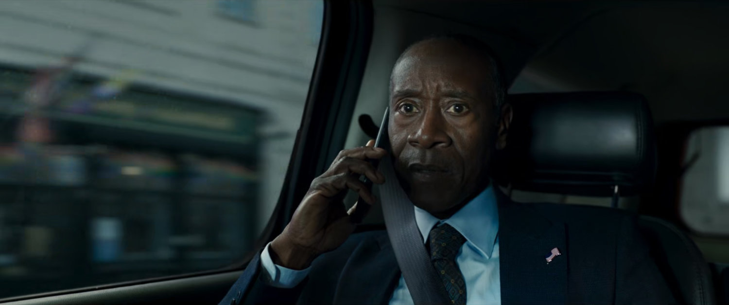 James Rhodes on phone in back of car.