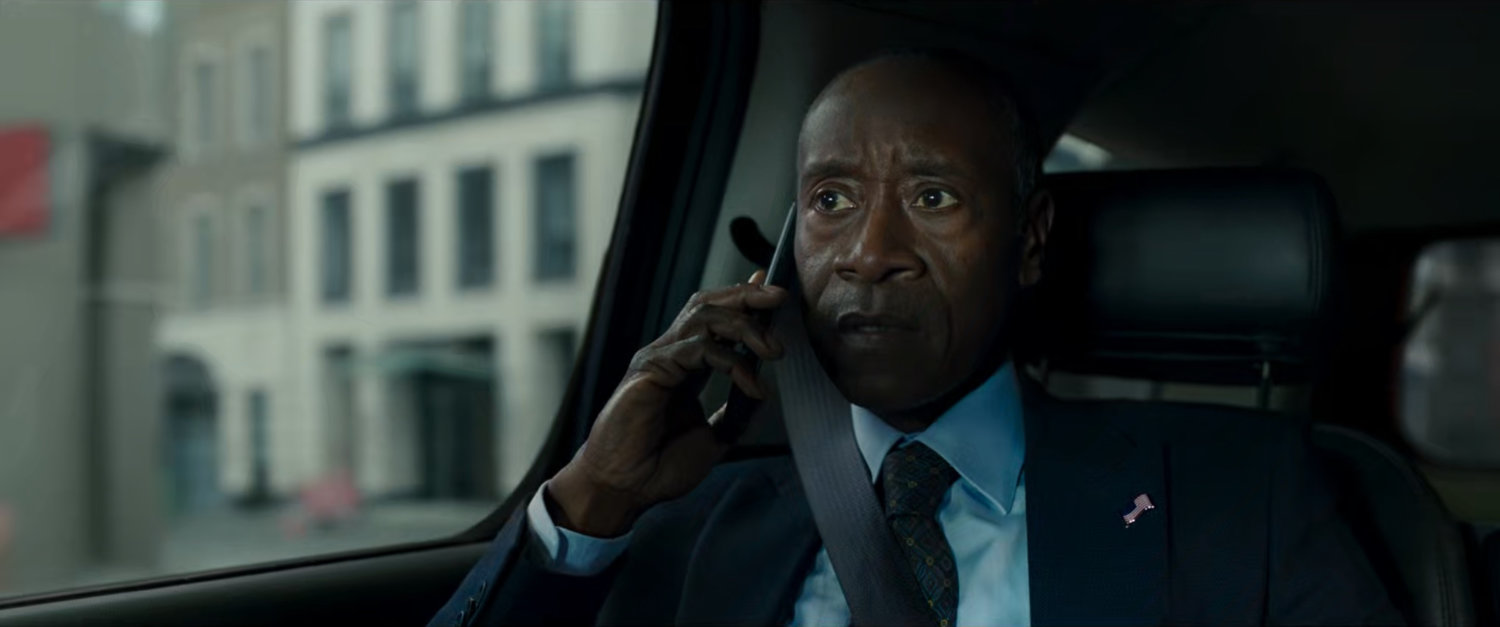 James Rhodes on phone in back of car.