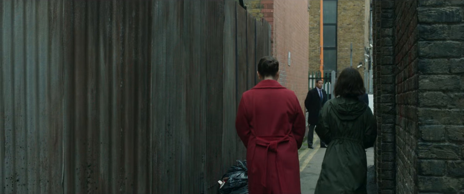 G'iah walks with Sonya Falsworth in a London alley.