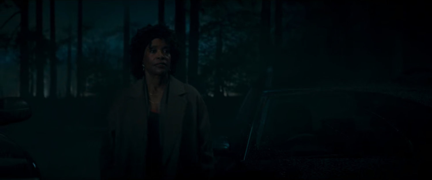 Priscilla in a dark woods.