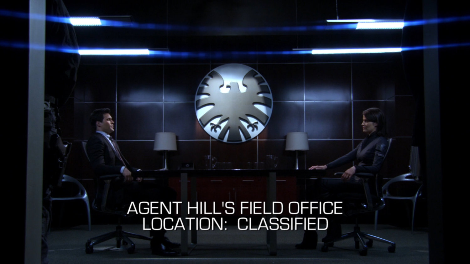 Grant Ward and Maria Hill in SHIELD Field Office. Text: Agent Hill's Field Office Location: Classified.