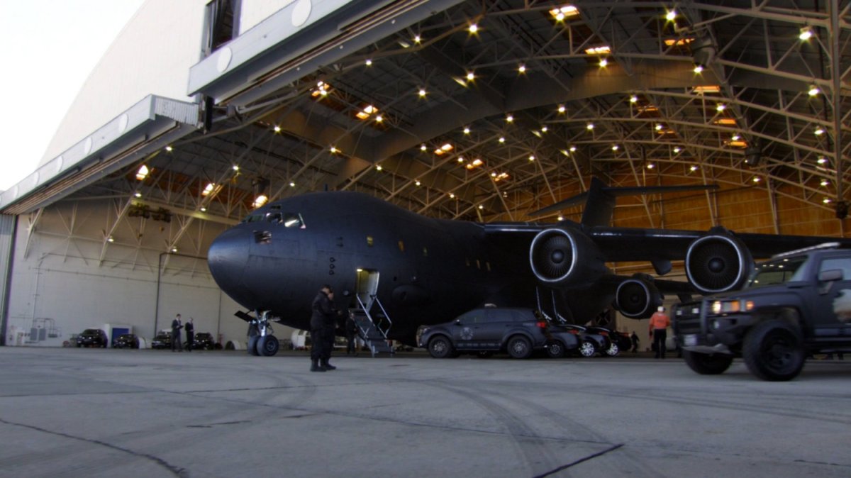 SHIELD vehicles and "The Bus" in airfield hangar.