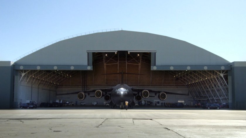 The Bus pulling out of airport hangar.