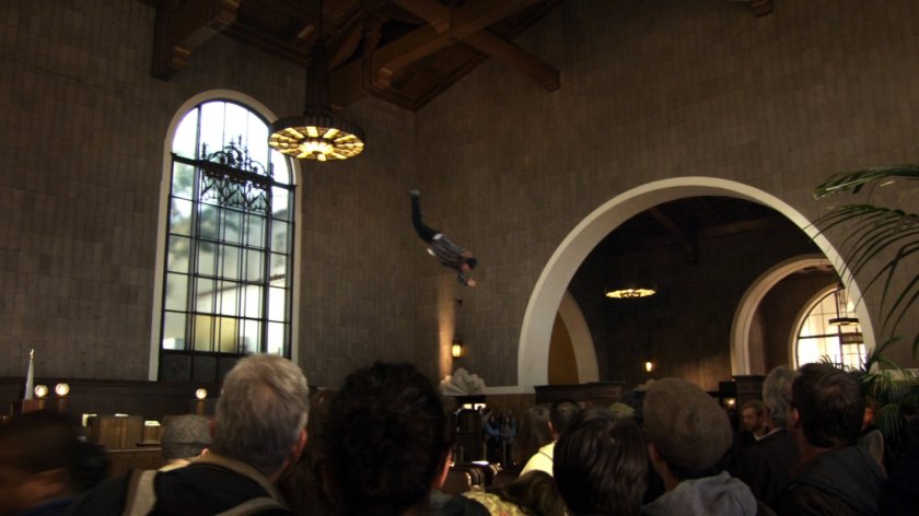 Man being thrown through crowded Union Station terminal.