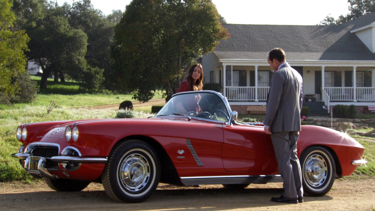 Exterior of Peterson Farm with Skye and Coulson standing by Lola.