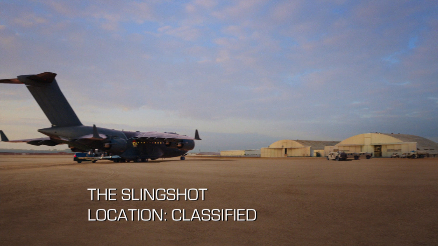 The Slingshot: A desert airfield. Text: The Slingshot, Location: Classified.