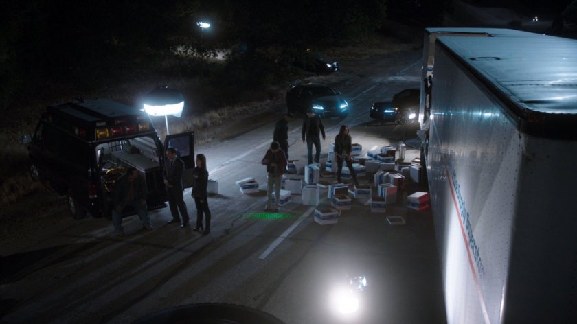 Agents investigate spilled debris from semi truck on Colorado highway.