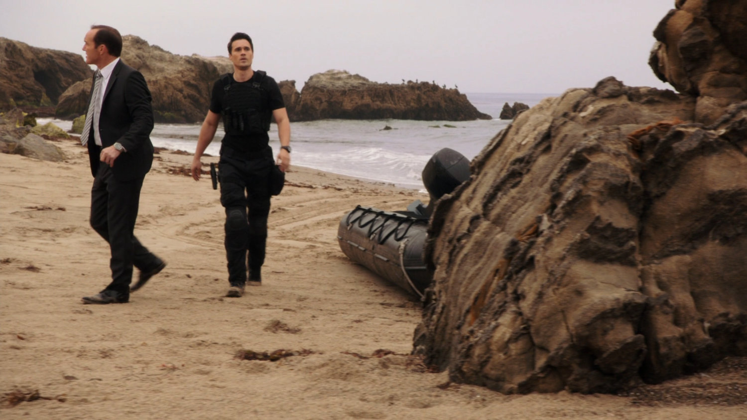 Coulson and Ward on a rocky beach.
