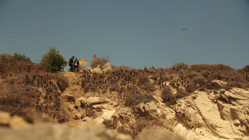 Coulson and Ward atop a bluff over a rocky beach.