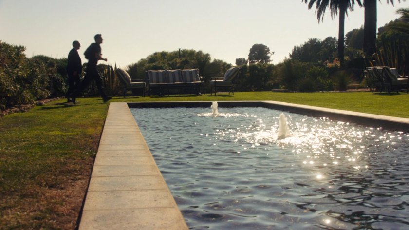 Ward and Coulson walk past Ian Quinn's fountains on his estate.