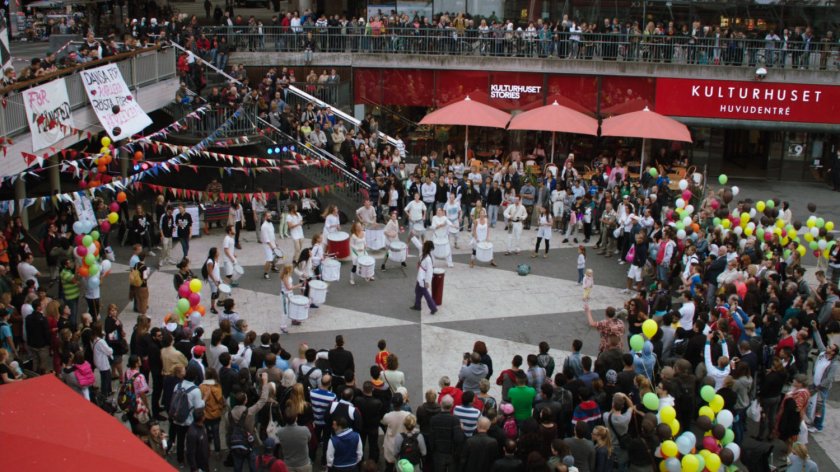 A marching band plays for crowds in the sunken plaza of Sergel's Square.